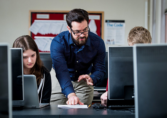 Computer Science professor answers a students' question during class