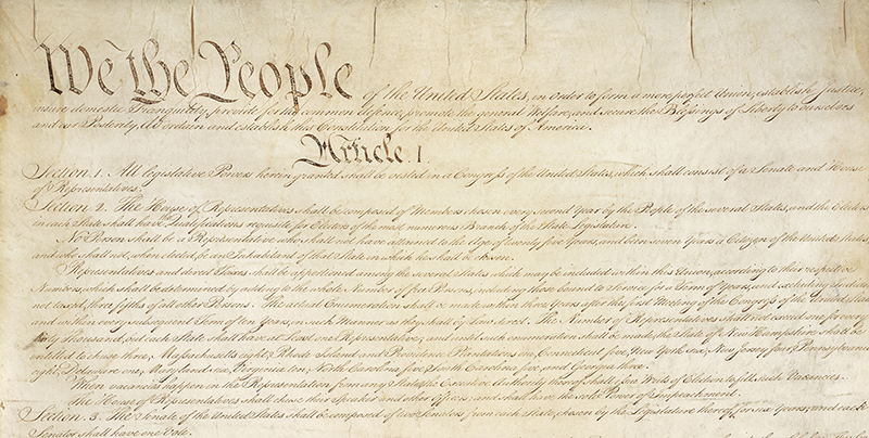 a photo of the United States Constitution document with the text "We the People" visible at the top
