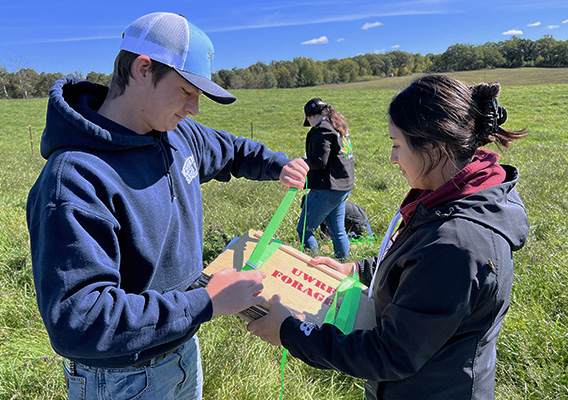 Two Crop and Soil students participate in a foraging exercise