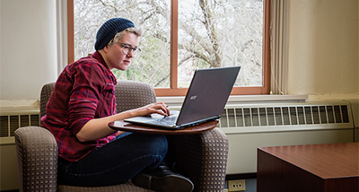 Data Science student takes notes on their laptop