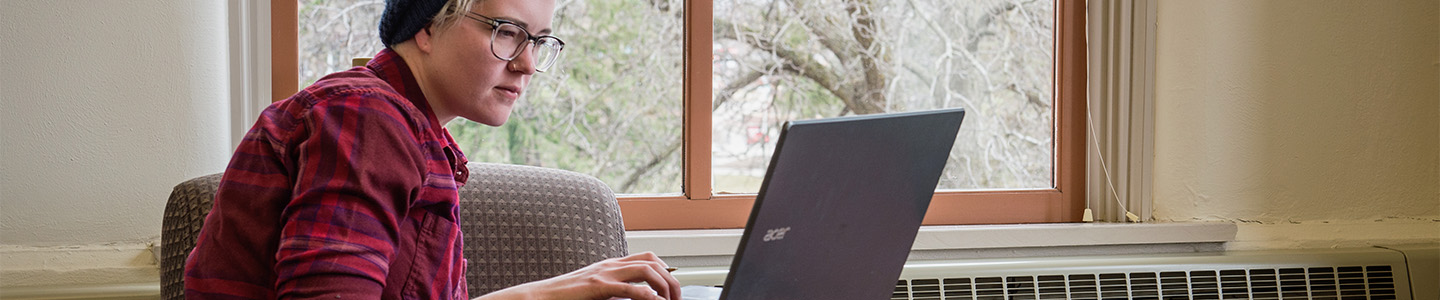 Data Science student takes notes on their laptop