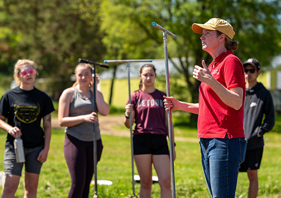 Environmental Science professor instructs a class in a hands on activity