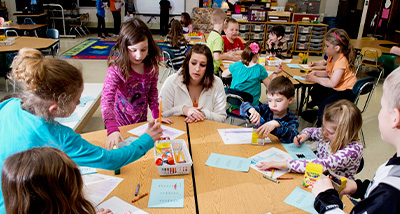 Elementary Education graduate student listens to their students during class