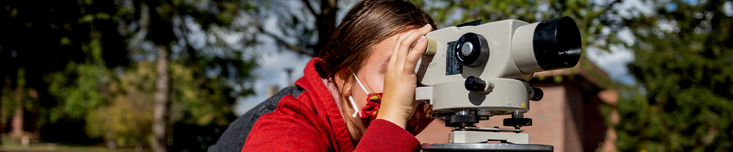 Environmental Engineering student using surveying equipment during class