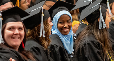 Student sits in the crowd at the graduation ceremony