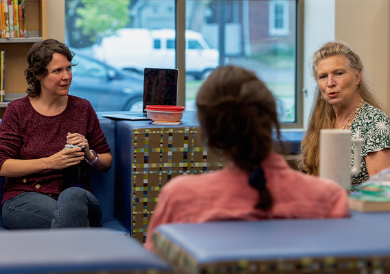 3 Counseling graduate students discuss coursework during class