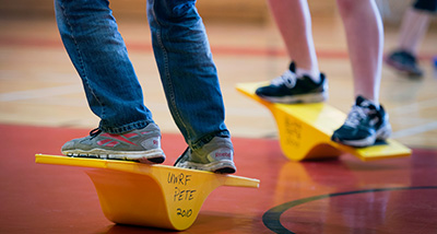 Physical Education students standing on balance boards