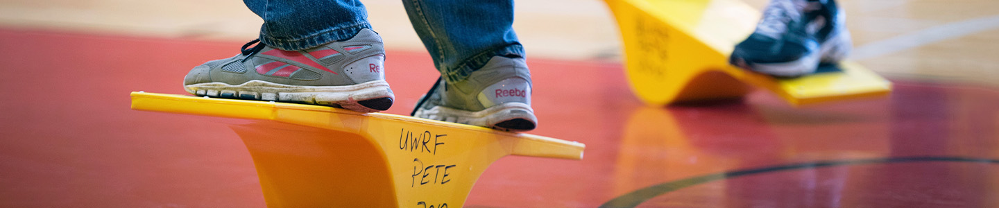 Physical Education students standing on balance boards