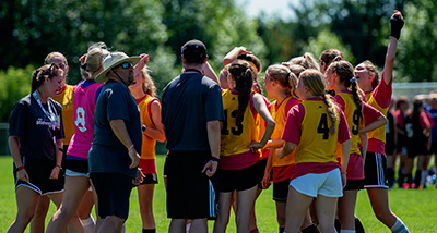 Intramural soccer players gathering for a huddle before a game