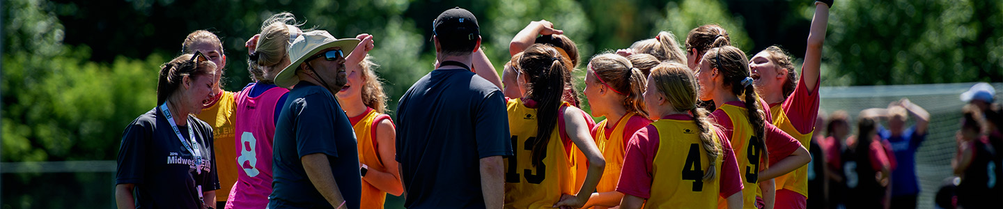 Intramural soccer players gathering for a huddle before a game