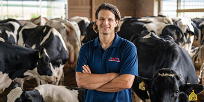 Kurt Vogel on campus farm with dairy cattle