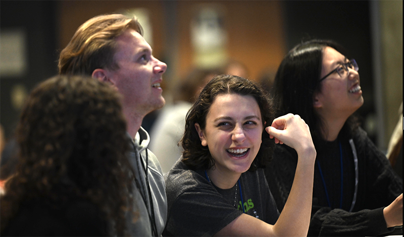 students laugh while looking off camera