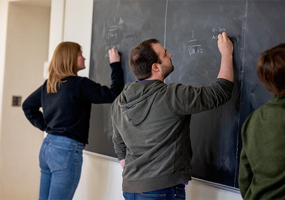 Three graduate students compete to see who can solve a math problem the fastest