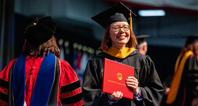 Student crosses stage and earns their Master's Degree