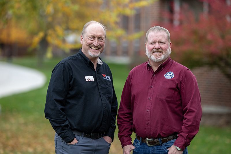 photo of Mike Orth and Matt Winsand standing in front of a building smiling at the camera.