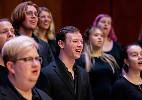 A group of students sing choir in Abbott Concert Hall in KFA.