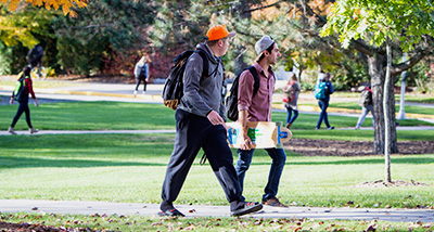 Two students walk to class on an afternoon in the fall