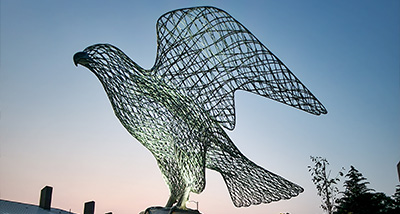 The falcon statue outside of Rodli Hall at dusk