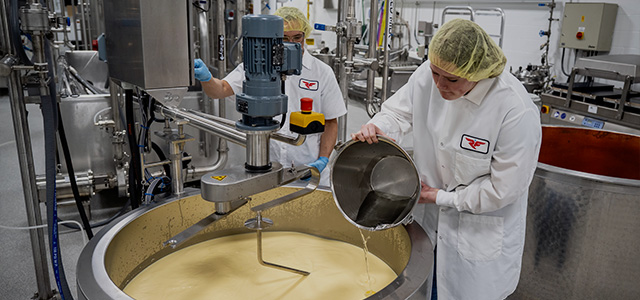 Two students prepare cheese in the Dairy Pilot plant