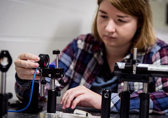 Physics student works on an experiment