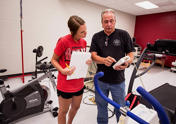 Physiology professor points to data on a medical device