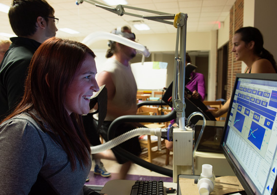 Physiology graduate student views their data during a exercise experiment