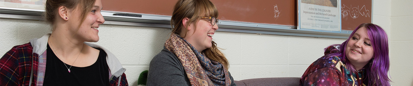 Three Psychology students discuss coursework during class