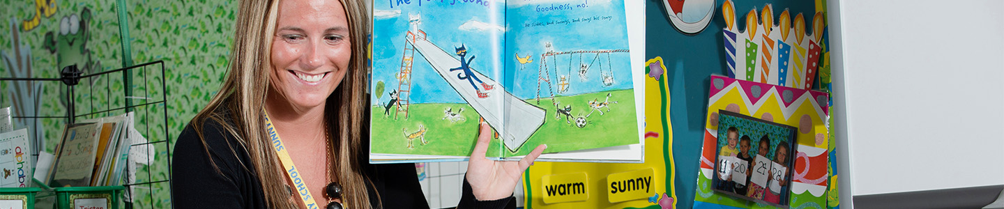 Graduate student reads a children's book during their student teaching class
