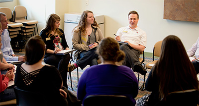 Group of School Supervision Graduate students sit in a circle and have a discussion