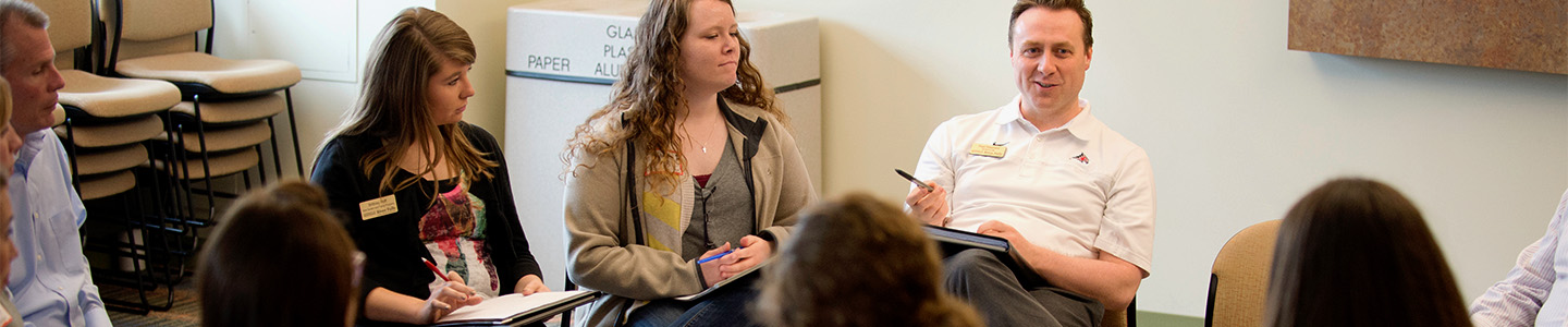 Group of School Supervision Graduate students sit in a circle and have a discussion