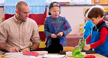 A student teacher helping a child during their class time