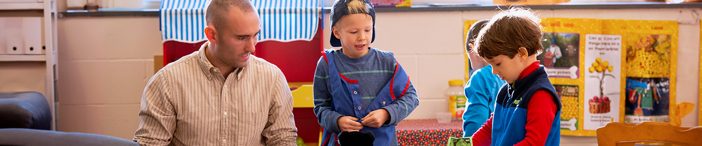 A student teacher helping a child during their class time