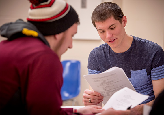 Art student studies their script during a screenwriting class