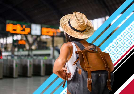 person in a airport looking at a board of flight information