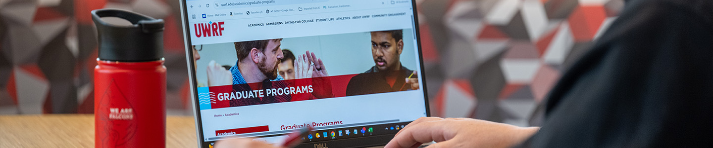 A prospective graduate student views all the graduate programs that UWRF offers on a laptop