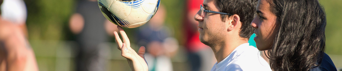 Student balances a soccer ball on their fingertips