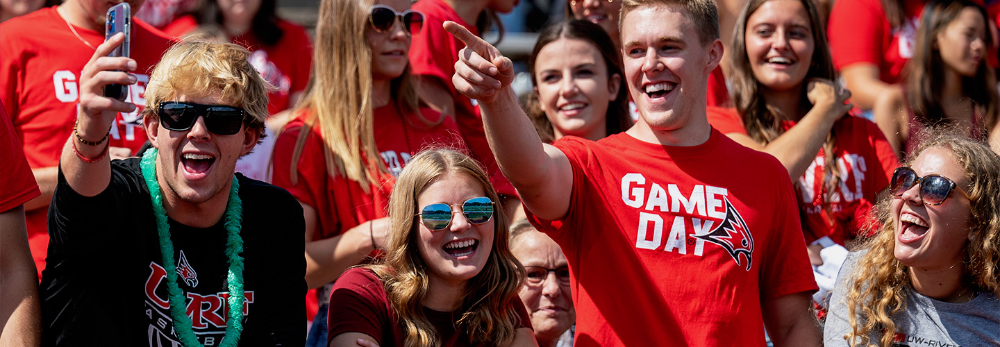 Students cheer for the UWRF Football team during a game at Ramer Field
