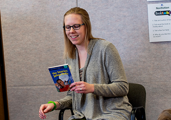 Student teacher reads a children's book to their class