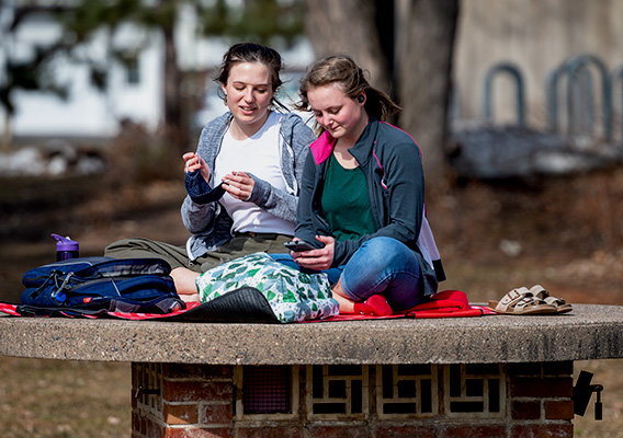 Students on campus sitting around and talking