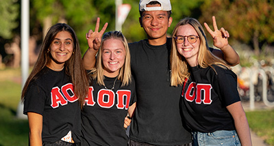 Four students gather at the campus Homecoming events