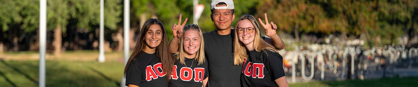 Four students gather at the campus Homecoming events