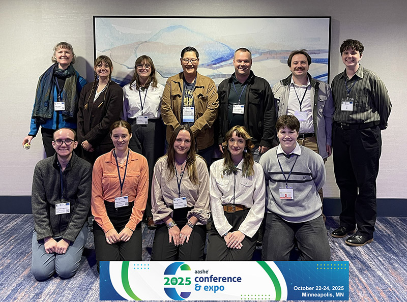students and staff pose in two rows 