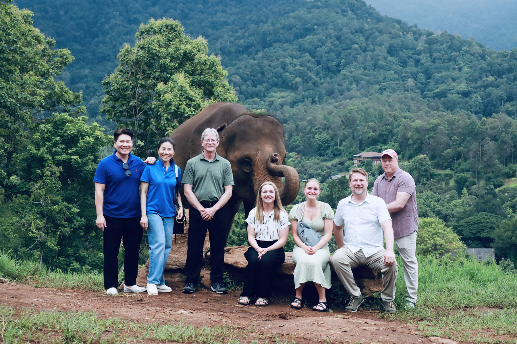 a group pose with an elephant in Thailand