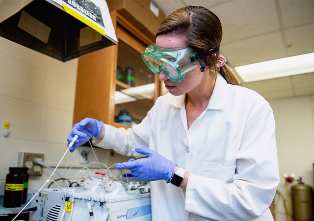 Environmental Science student conducting an experiment in a lab