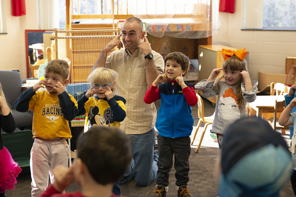 TEACHER SINGING WITH PRESCHOOL STUDENTS