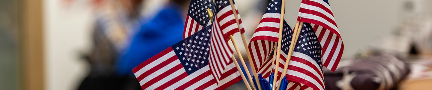 A jar full of small American flags in the Veterans Services office