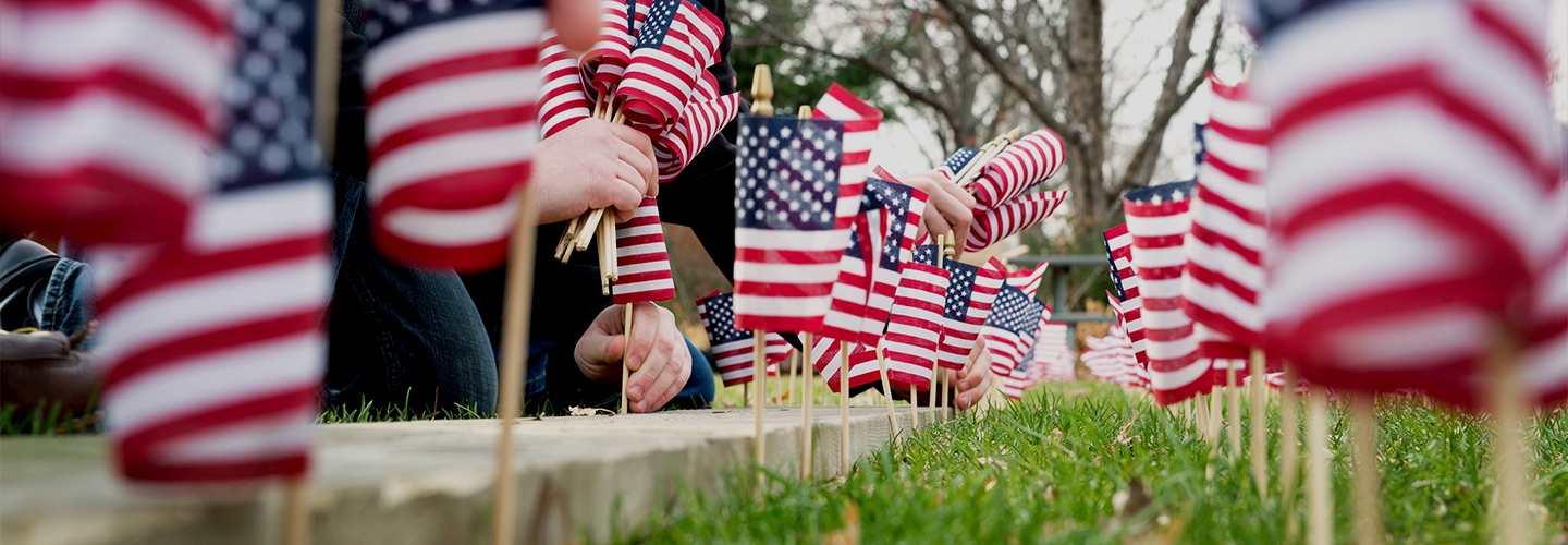 Student Veterans place flags in the ground outside the University Center on Veteran's Day. 